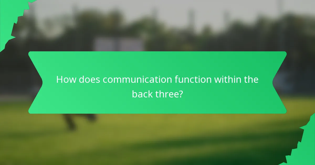 How does communication function within the back three?