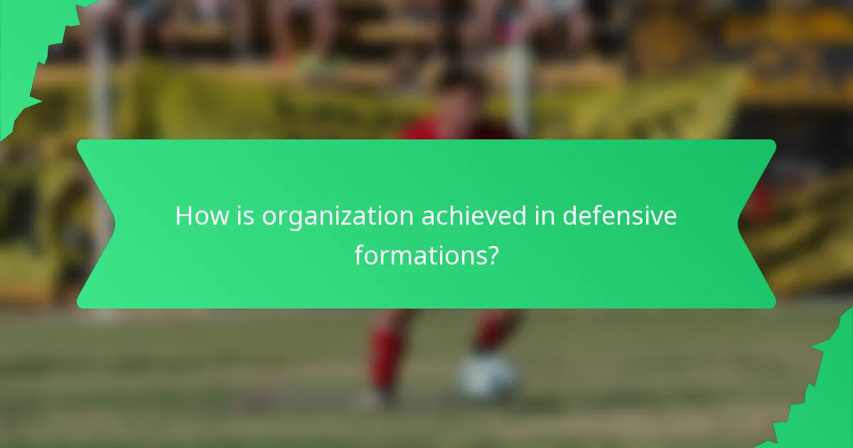How is organization achieved in defensive formations?